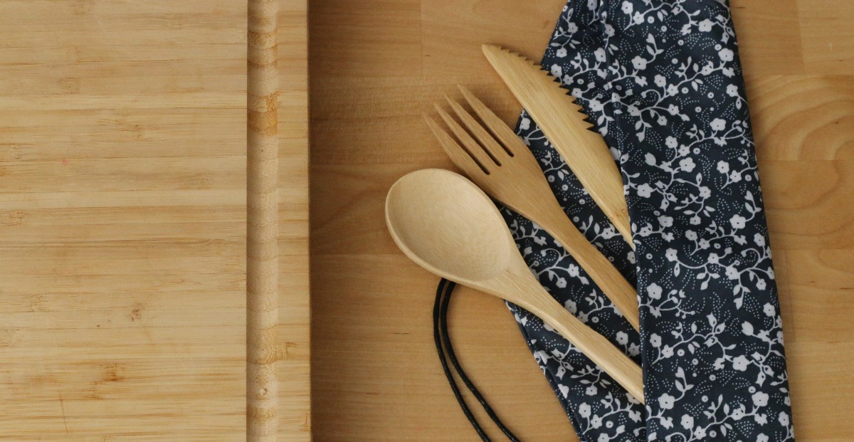 Wooden Utensils on wooden board in a black carrying case are an example of sustainable home goods